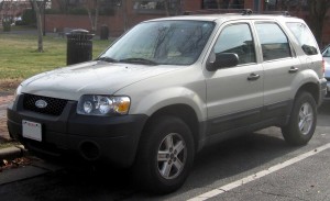Silver Ford Escape SUV parked on the street, viewed from the front passenger side.