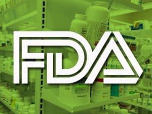 FDA logo over shelves filled with various prescription medicine bottles in a pharmacy.