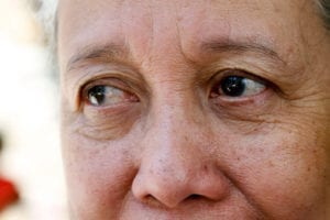Close-up of an older person's face, focusing on their eyes and upper cheeks.