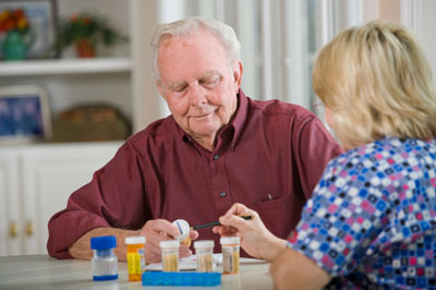 Elderly man being shown medications