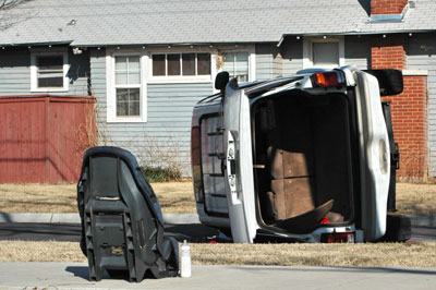 Vehicle rolled over and car seat on the street