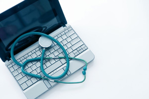 Laptop with stethoscope on top 