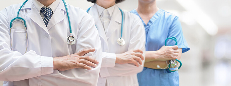 2 doctors and a nurse standing together