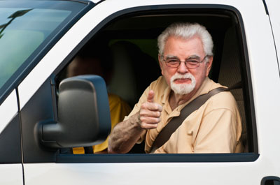 Man giving thumbs up in truck