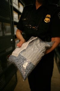 Viagra is so popular that it is a frequent target of counterfeiters. Here, a U.S. Customs and Border Patrol agent displays his seized goods. 