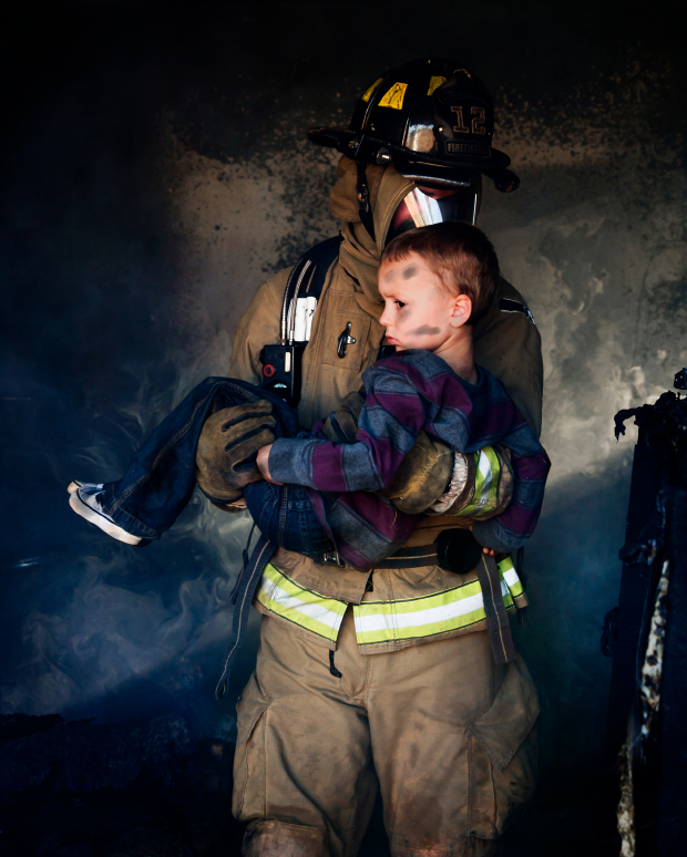 Firefighter Carrying Boy