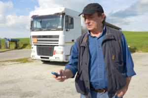 truck driver with broken down truck calling for help