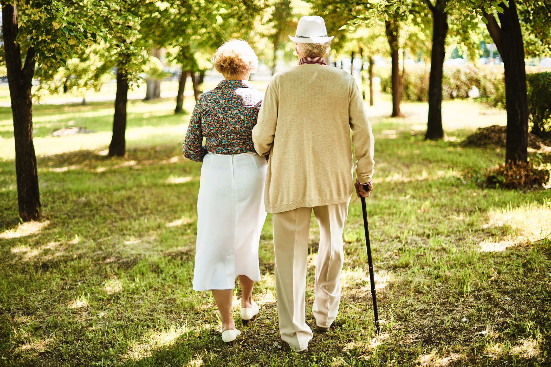 Пожилые держатся за руки. Пожилая пара. Прогулка пожилых. Пожилые люди. Пенсионеры на прогулке.