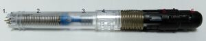 Cross-section of a recalled EpiPen with six labeled parts, showing internal structure.