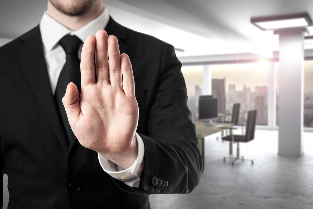 businessman in modern office room hand stop gesture