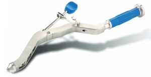 A stainless steel orthopedic bone drill with blue handle and thumb lever from Greatbatch Medical.