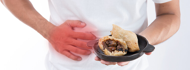 man holding food with an upset stomach