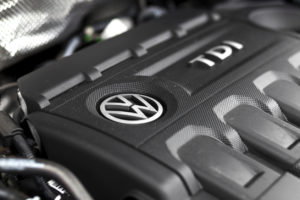 Close-up of a Volkswagen TDI engine cover with the VW logo visible.