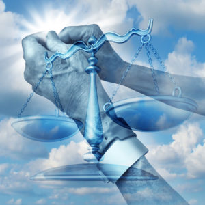 A hand in handcuffs holds scales, symbolizing Amendment 7, against a cloudy sky background.