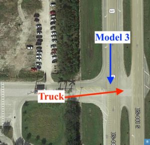 Aerial view of a truck and Model 3 approaching an intersection from different directions.