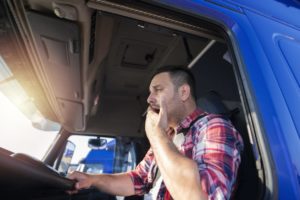 Tired truck driver yawns