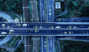 Aerial view of cars on a highway with graphics representing autonomous vehicle technology.