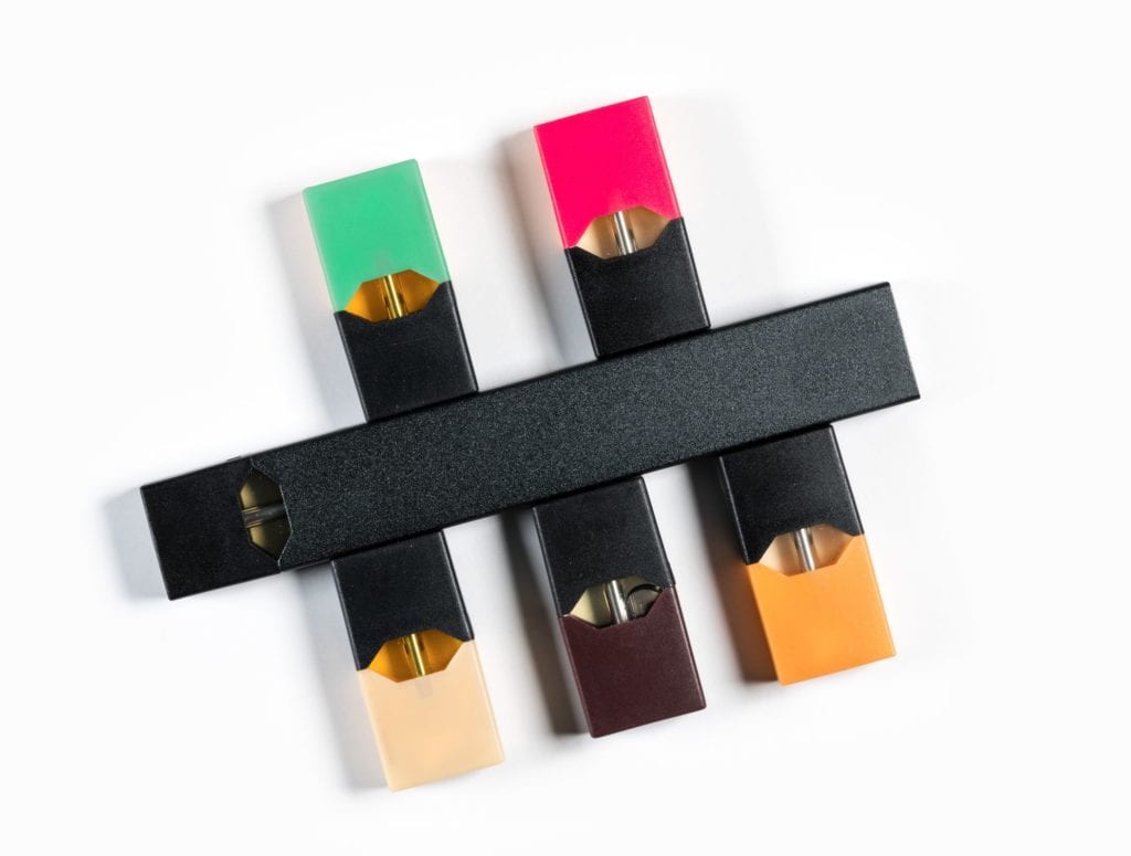 Image of Juul-like vaping devices and various refill pods of different colors
