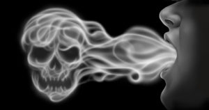 A person exhales smoke forming the shape of a skull against a black background.