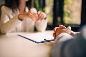 Lawyer Presenting Settlement Sheet to Client 