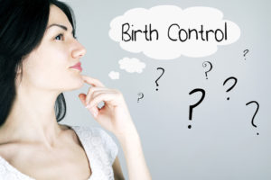 Woman thinking with "Birth Control" and question marks in thought bubbles around her head.