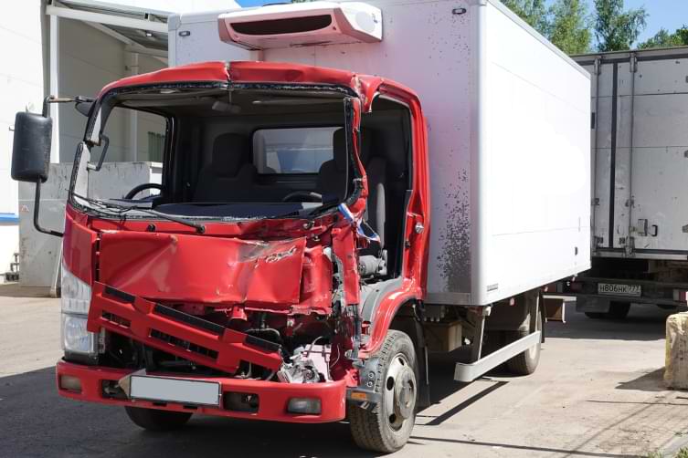 Truck sitting in a parking lot with front smashed in after truck accident 