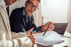 Businessman pointing place in contract where client have to sing