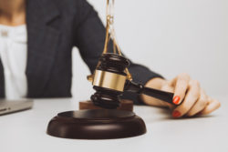 Woman notary with wooden gavel isolated,