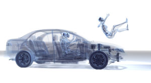 Transparent car with visible skeletons; one skeleton is being ejected from the passenger seat.