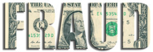The word "FRAUD" cut out over a U.S. one-dollar bill background.