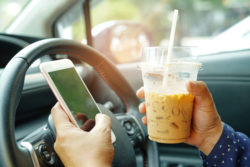 lady holding ice coffee and mobile phone at car to communication with friends in happy hot holiday.