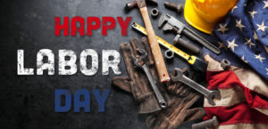 Tools, gloves, hard hat, and U.S. flag with "Happy Labor Day" text on a dark background.
