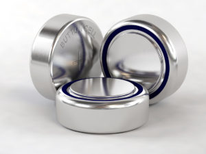 Three silver button cell batteries on a white background, one displaying the label "BUTTON CELL.