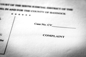 Close-up of a legal document with the word "COMPLAINT" and a blank case number field.