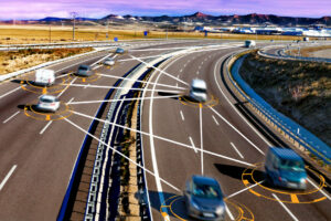 Several cars on a highway with digital lines illustrating vehicle connectivity and communication.