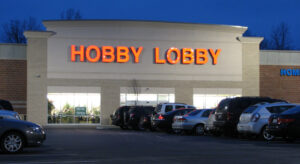 The front entrance of a Hobby Lobby store, known for its Supreme Court case, at dusk.