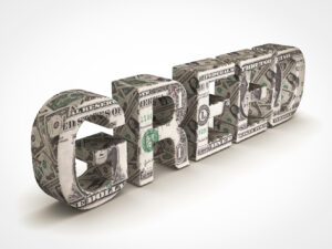 The word "GREED" formed from three-dimensional letters covered in U.S. dollar bills.